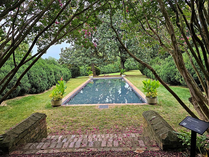 The reflecting pool, garden area, and brick sidewalks in Morven Park gardens.
