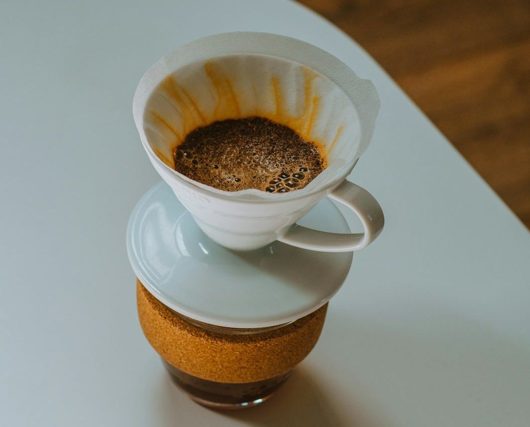 white ceramic cup with brown liquid on white ceramic saucer white ceramic cup with brown liquid on white ceramic saucer