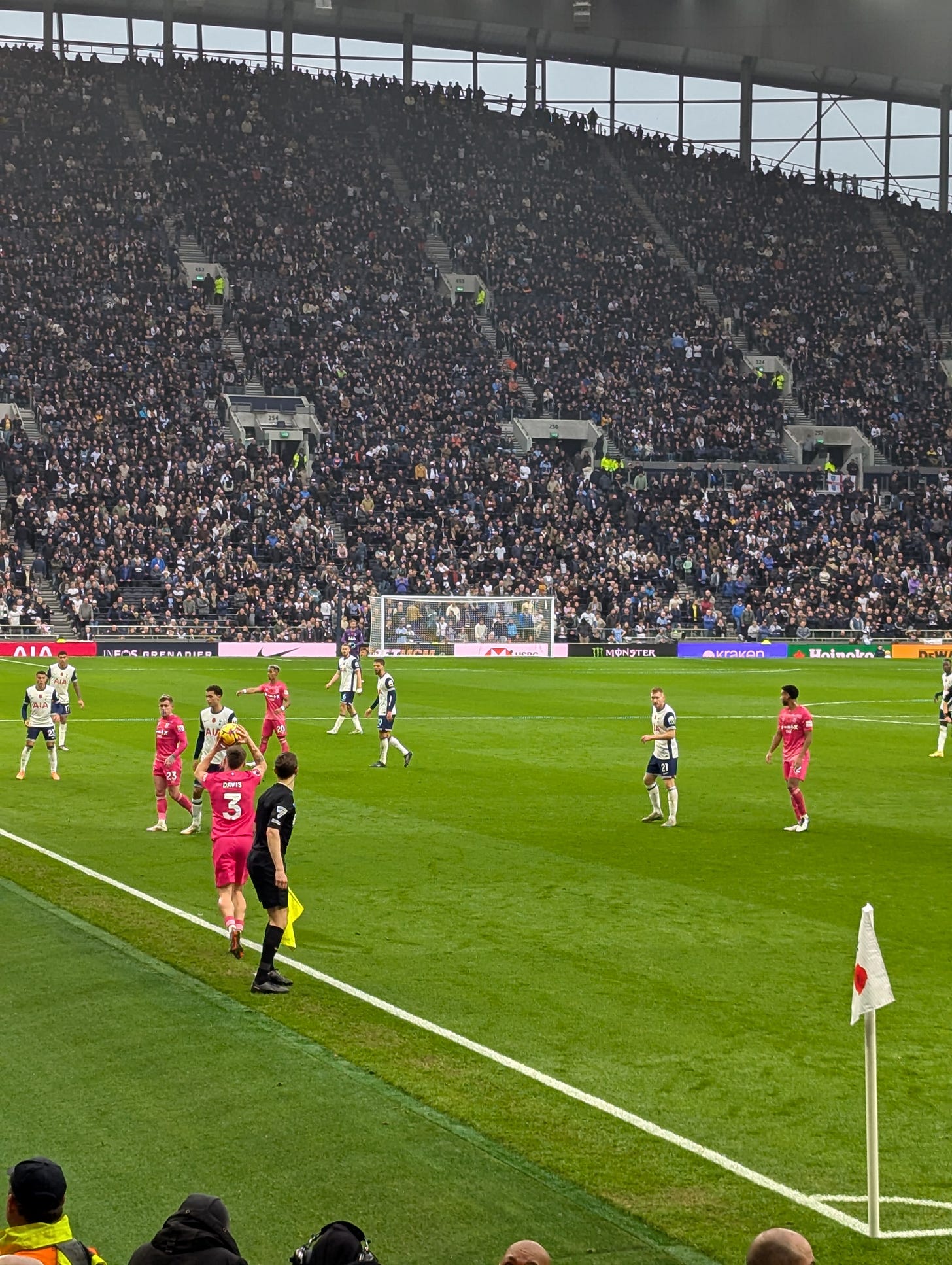 Leif Davis takes a throw from the left back area, the big South Stand Kop looms in the background