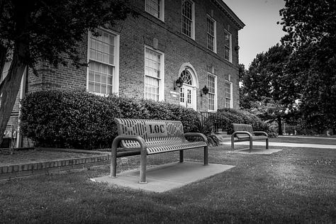 scenes from around campus including a dedication from the Class of 1977, a poem about the alma mater, historical markers, and images of historical hallway in admin building