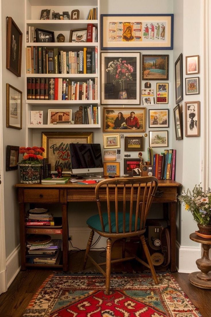 This may contain: a home office with bookshelves and pictures on the wall