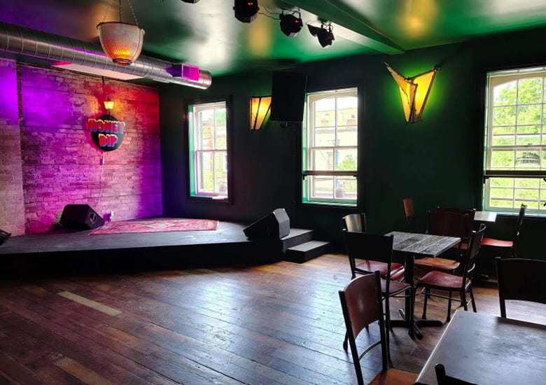 The image depicts a cozy, minimalist stage setting with a red carpet and wooden floor, lit by a green hue, featuring a black and white color scheme, and adorned with black and red geometric shapes.
AI-generated content may be incorrect. The image depicts a cozy, minimalist stage setting with a red carpet and wooden floor, lit by a green hue, featuring a black and white color scheme, and adorned with black and red geometric shapes.
AI-generated content may be incorrect.