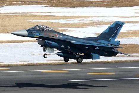 A military jet taking off

Description automatically generated
