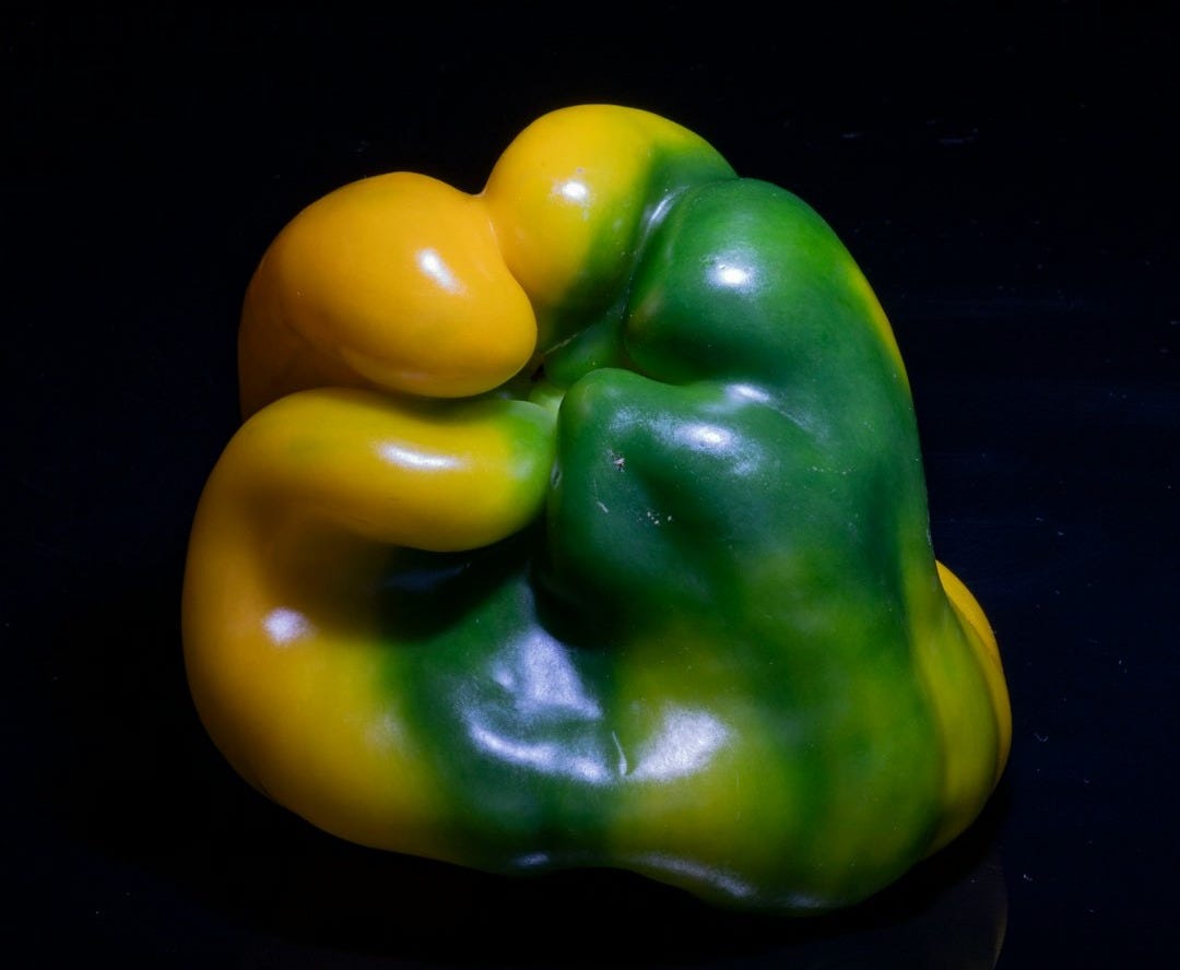 Yellow and green bell pepper on a reflective black surface. Yellow and green bell pepper on a reflective black surface.