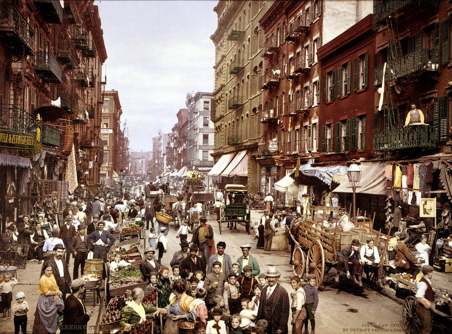 Crowded Mulberry Street around 1900, with pedestrians, pushcarts, storefronts and horse-drawn wagons filling the immigrant neighborhood. Crowded Mulberry Street around 1900, with pedestrians, pushcarts, storefronts and horse-drawn wagons filling the immigrant neighborhood.