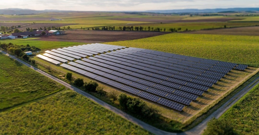 black solar panels on green grass field during daytime