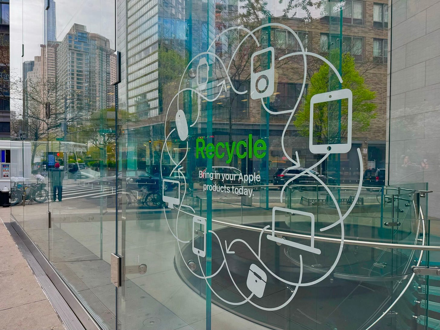 A vinyl decal on the windows of Apple Upper West Side. The decal says, "Recycle – Bring in your Apple products today." A vinyl decal on the windows of Apple Upper West Side. The decal says, "Recycle – Bring in your Apple products today."