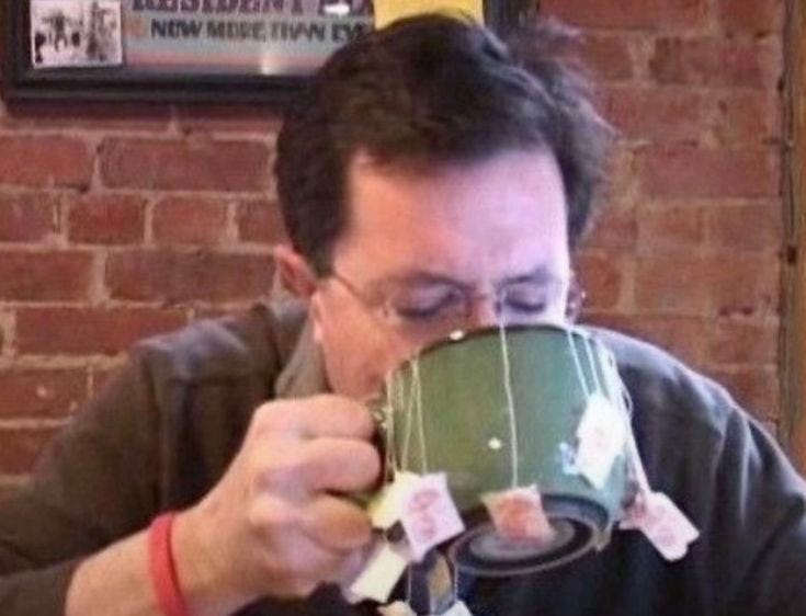 This may contain: a man drinking out of a coffee cup
