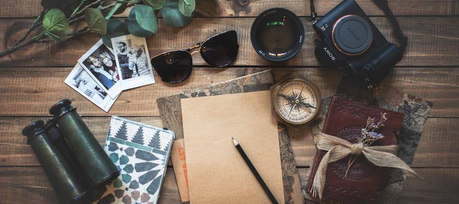 Notes, compass, camera, photos, binoculars for planning