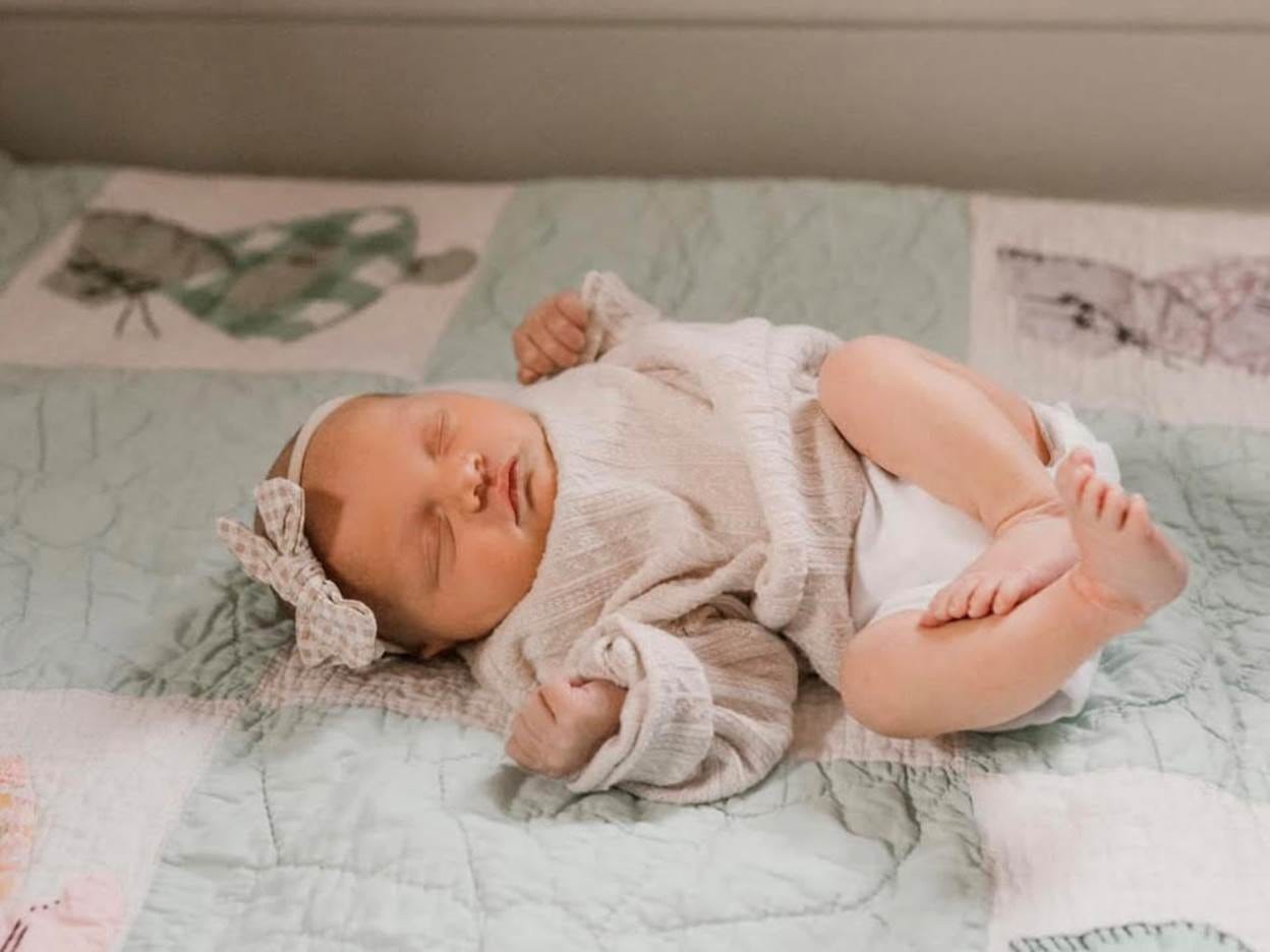 A new baby sleeping on our Sunbonnet Sue quilt