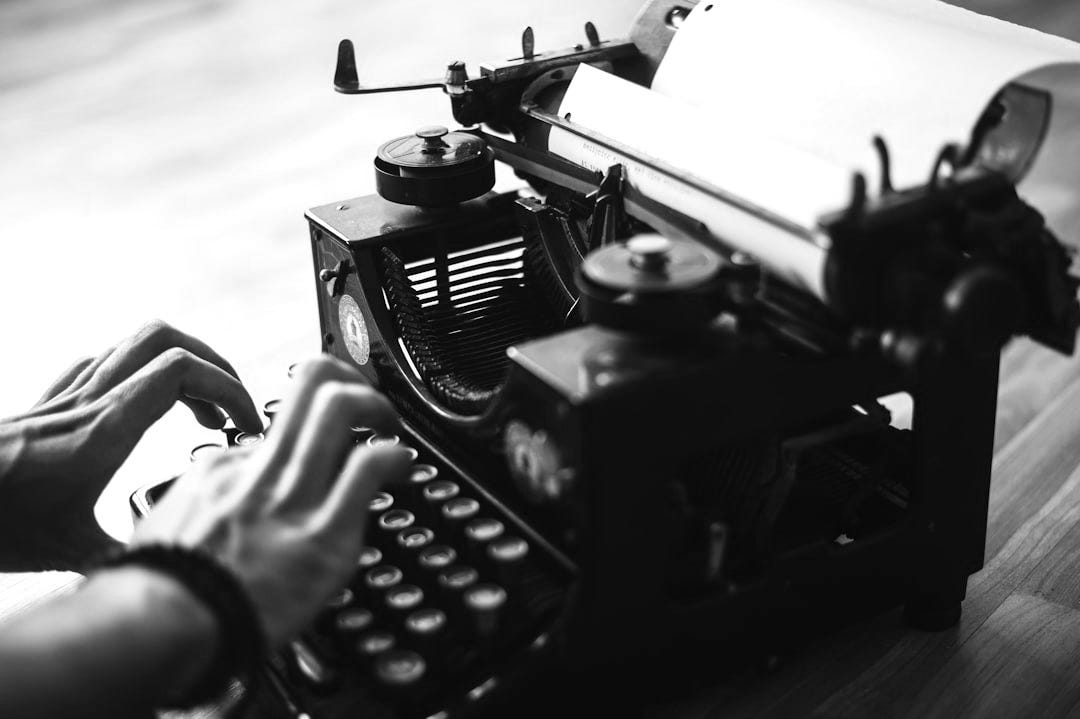 person using typewriter person using typewriter