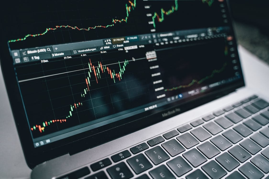 Free Black and Silver Laptop with Stock Market Display on Screen Stock Photo