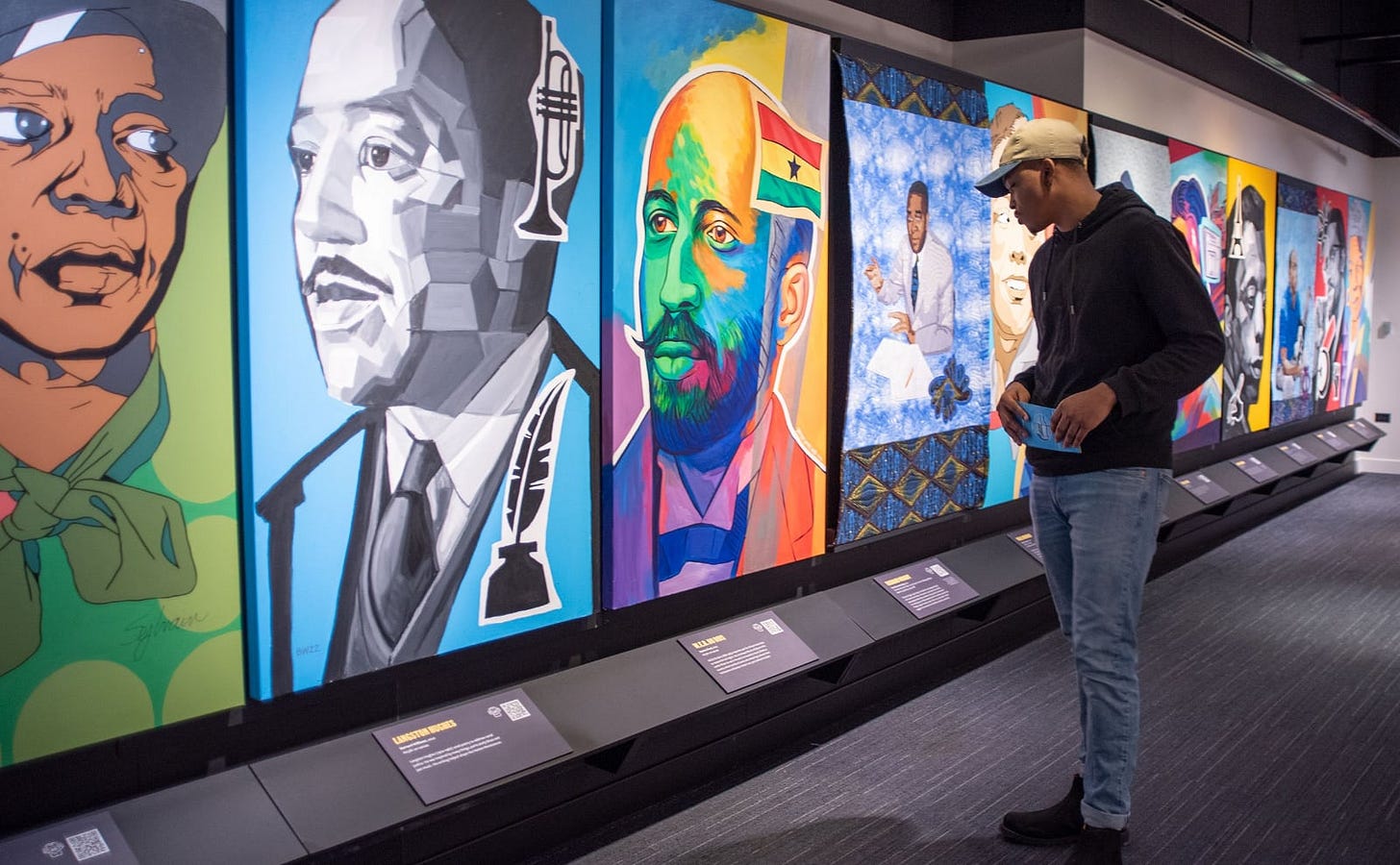 colorful posters of authors of color hung on the walls at the american writers museum