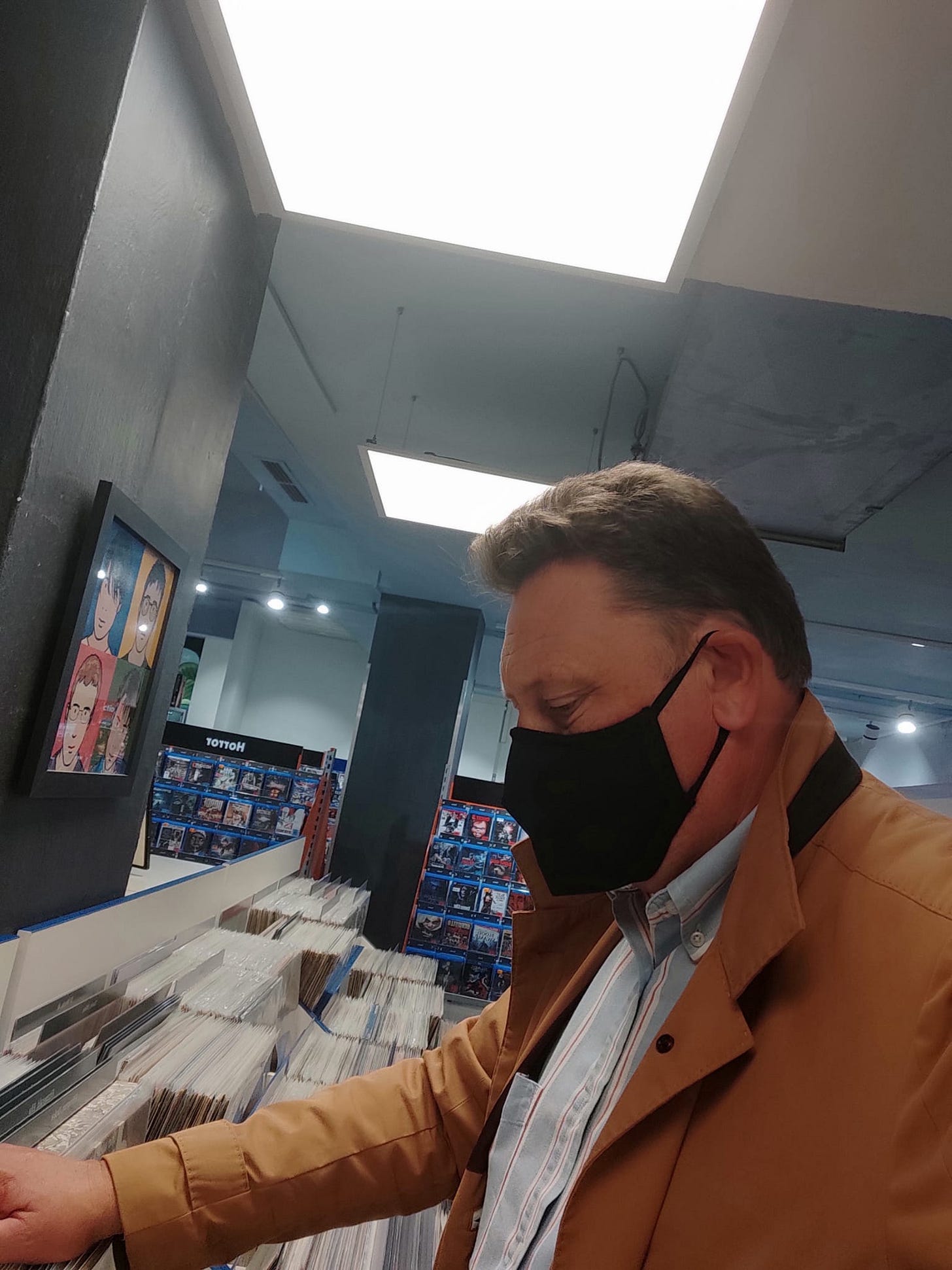 Gav browsing LPs in a record shop