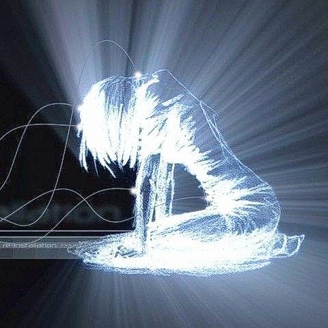 This may contain: a person sitting in front of a laptop computer on top of a table with light streaming through it