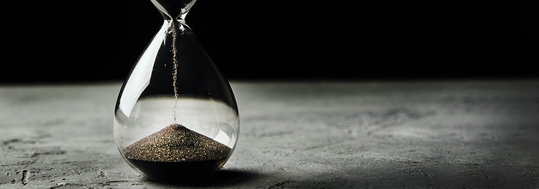 Hourglass on a dark background, long banner. Urgency and running out of time concept By Lazy_Bear Hourglass on a dark background, long banner. Urgency and running out of time concept By Lazy_Bear