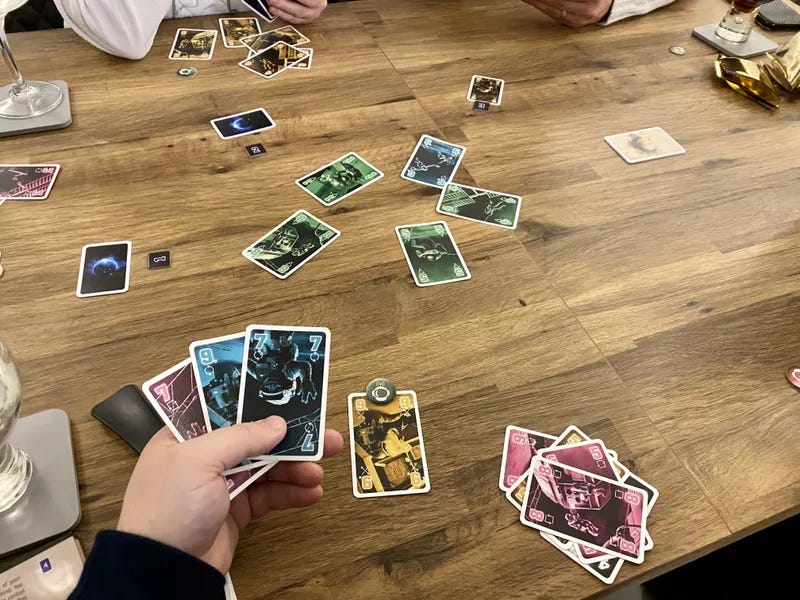 An example of The Crew being played, with a POV of a hand of cards hidden from other players and a yellow 9 on the table. A token at the top of the yellow 9 tells the other players it is the highest valued yellow card they have. An example of The Crew being played, with a POV of a hand of cards hidden from other players and a yellow 9 on the table. A token at the top of the yellow 9 tells the other players it is the highest valued yellow card they have.