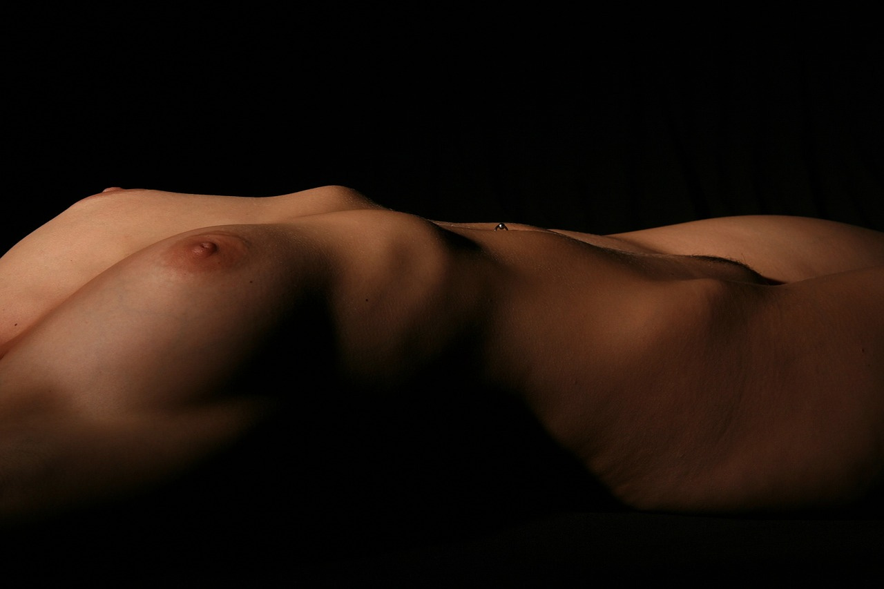 woman's breasts against dark background