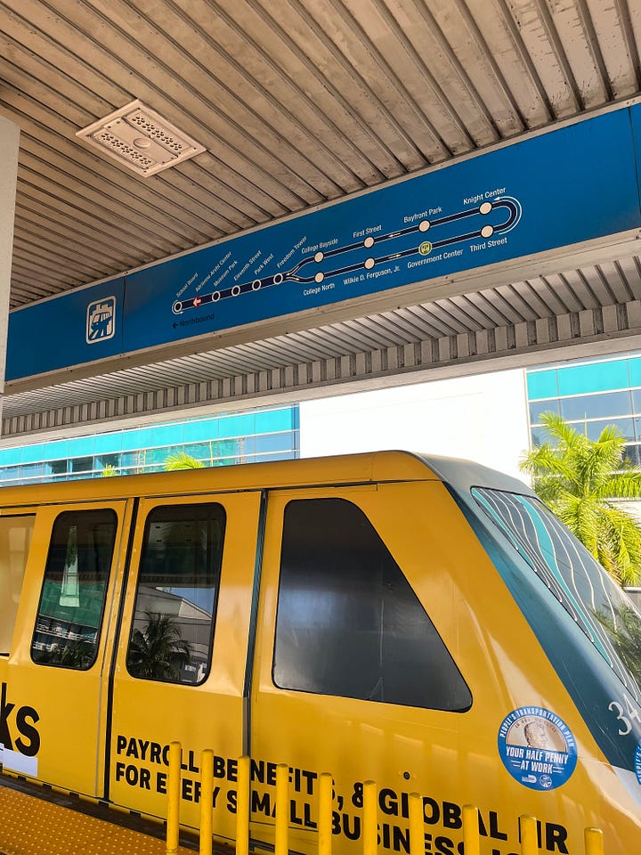 On the left is an image of the yellow-and-pink Brightline train and on the right is an image of the yellow Metromover with the sign above showing the route
