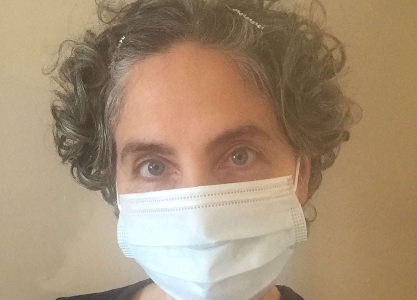Photo of Jennifer Garam wearing a surgical mask early in the pandemic