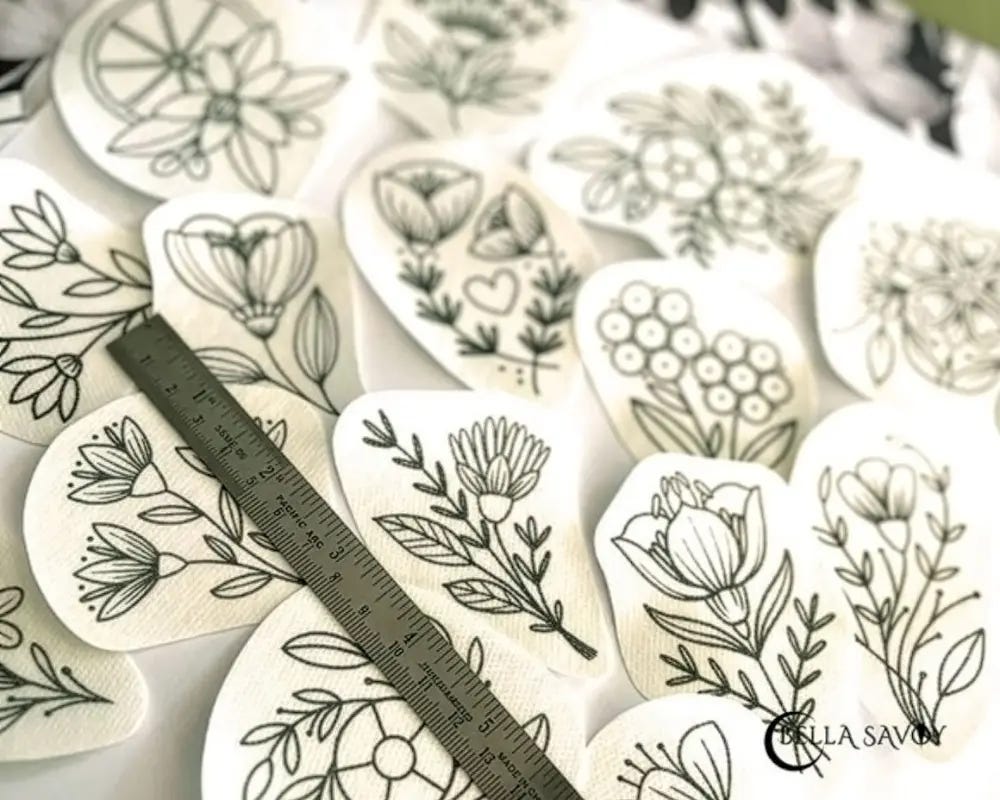 flower embroidery stick and stitch designs cut out and laid out next to each other