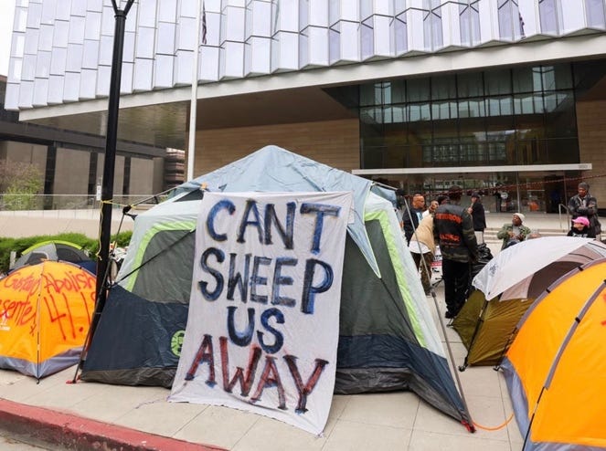 A group of tents outside a building

AI-generated content may be incorrect.