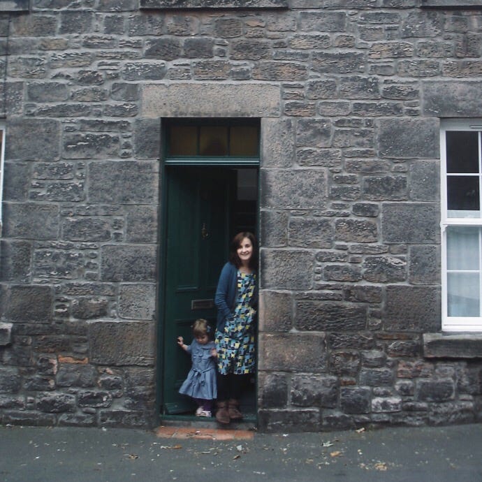 Picture of toddler standing in a window and Helen and Pie at their front door when Pie was about 4 years old