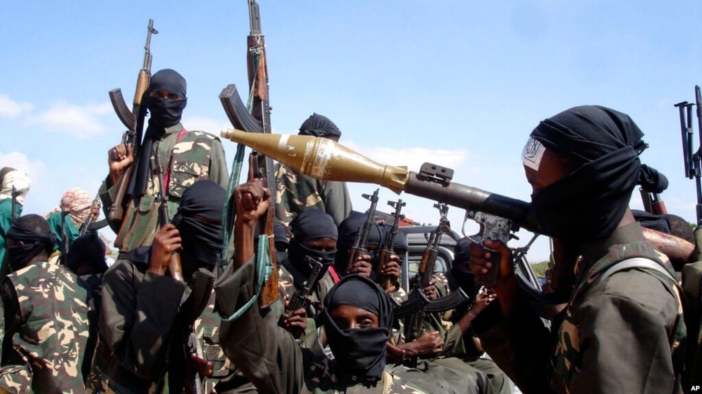 FILE - Armed al-Shabab fighters ride on pickup trucks as they prepare to travel into the city, just outside the capital Mogadishu, in Somalia, Dec. 8, 2008.