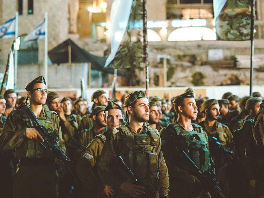 group of armed men with white flag