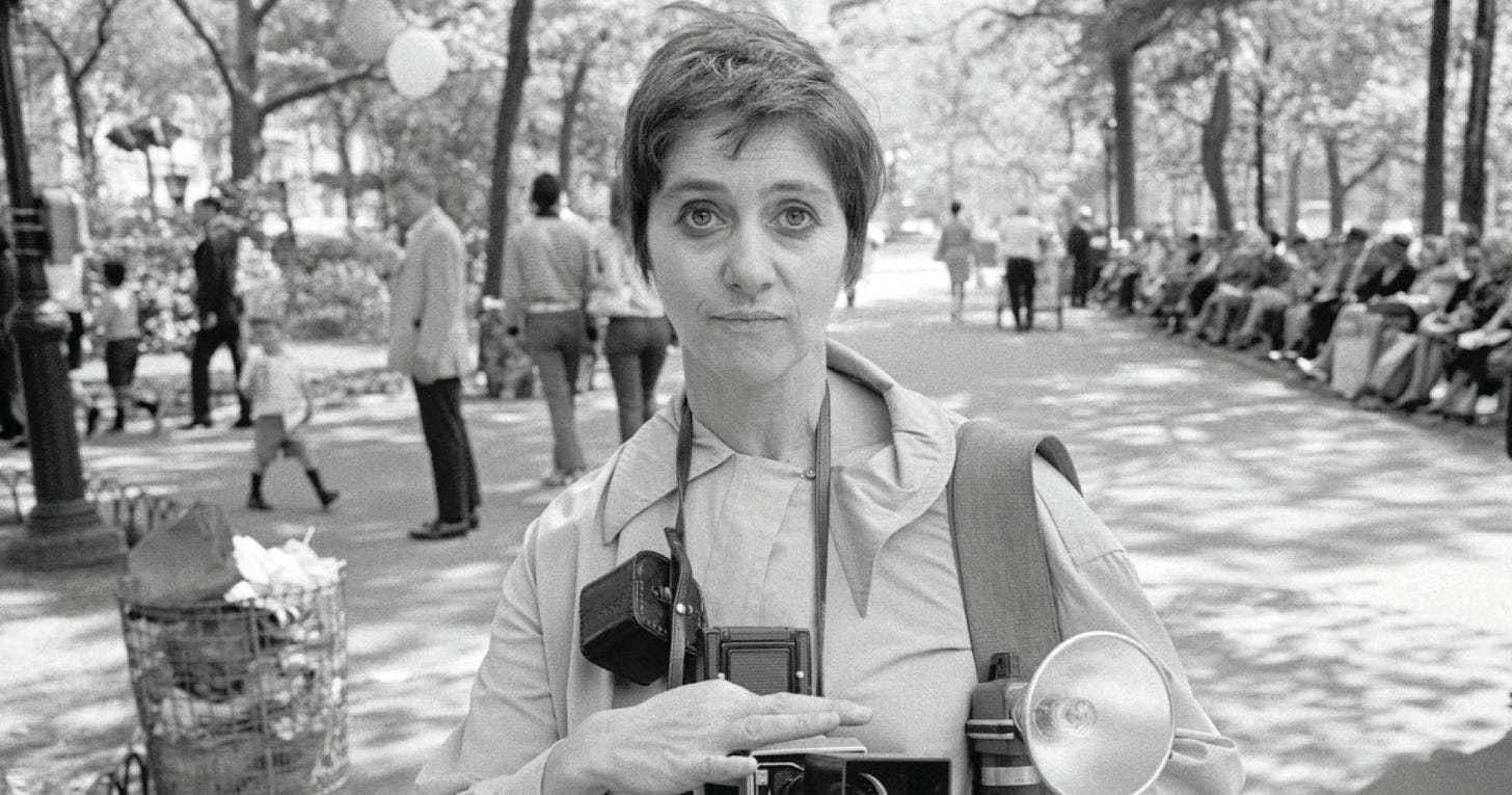 Diane Arbus with camera in park. Diane Arbus with camera in park.