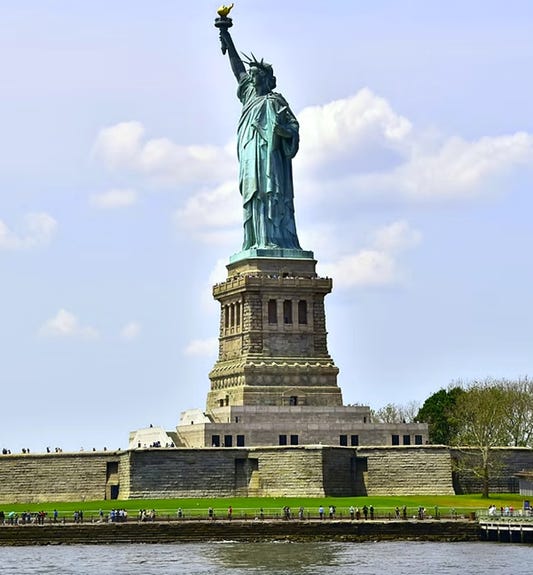 A statue of liberty with a body of water and a body of water

AI-generated content may be incorrect.
