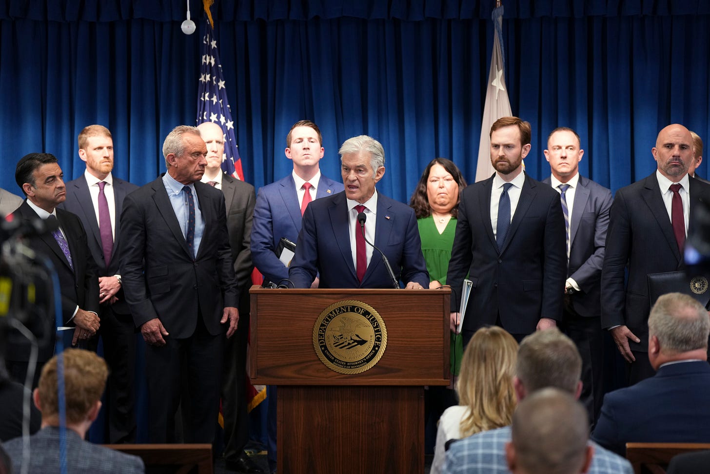 Dr. Mehmet Oz speaks at a DOJ podium alongside RFK Jr. and federal officials announcing Medicaid fraud charges. Dr. Mehmet Oz speaks at a DOJ podium alongside RFK Jr. and federal officials announcing Medicaid fraud charges.