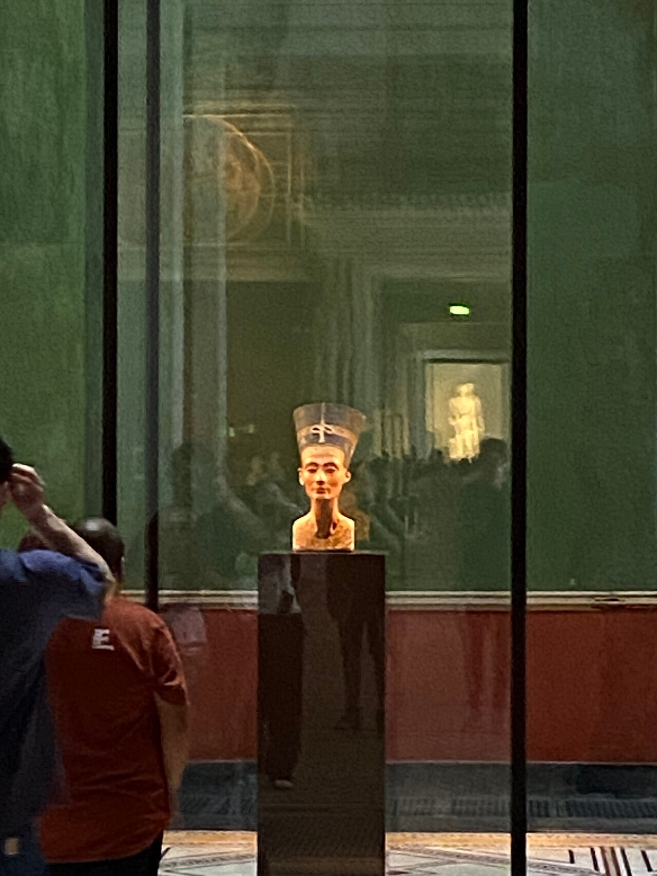 Painted bust of Queen Nefertiti in a tall crown Painted bust of Queen Nefertiti in a tall crown