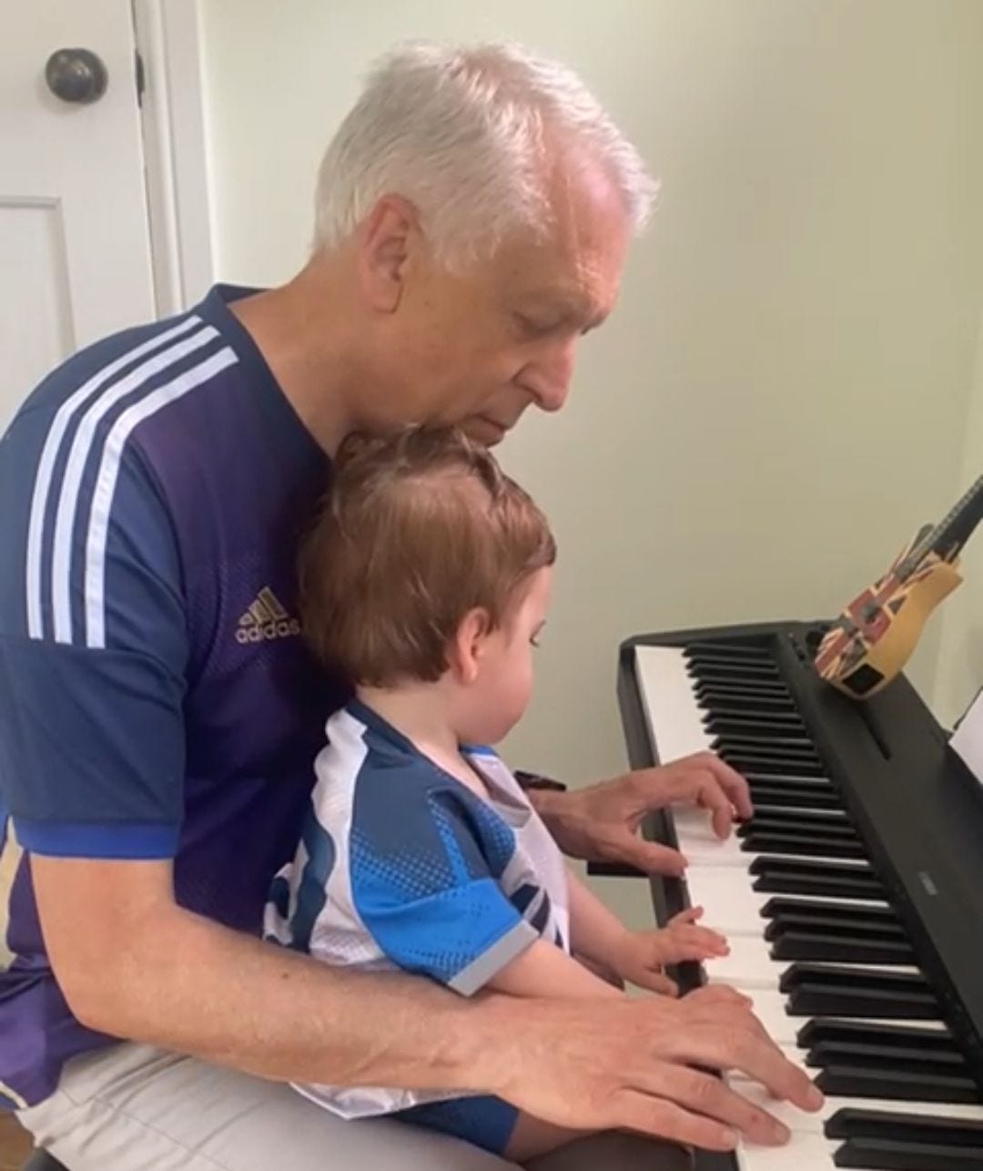 Alex Markham with his grandson at the piano