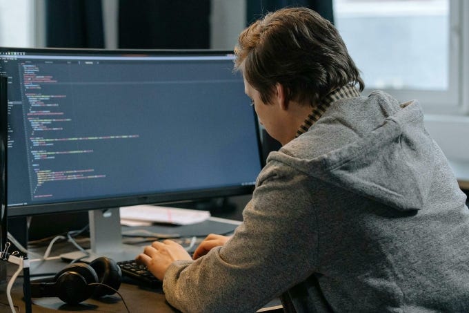 A person works on computer. Illustration from Pexels