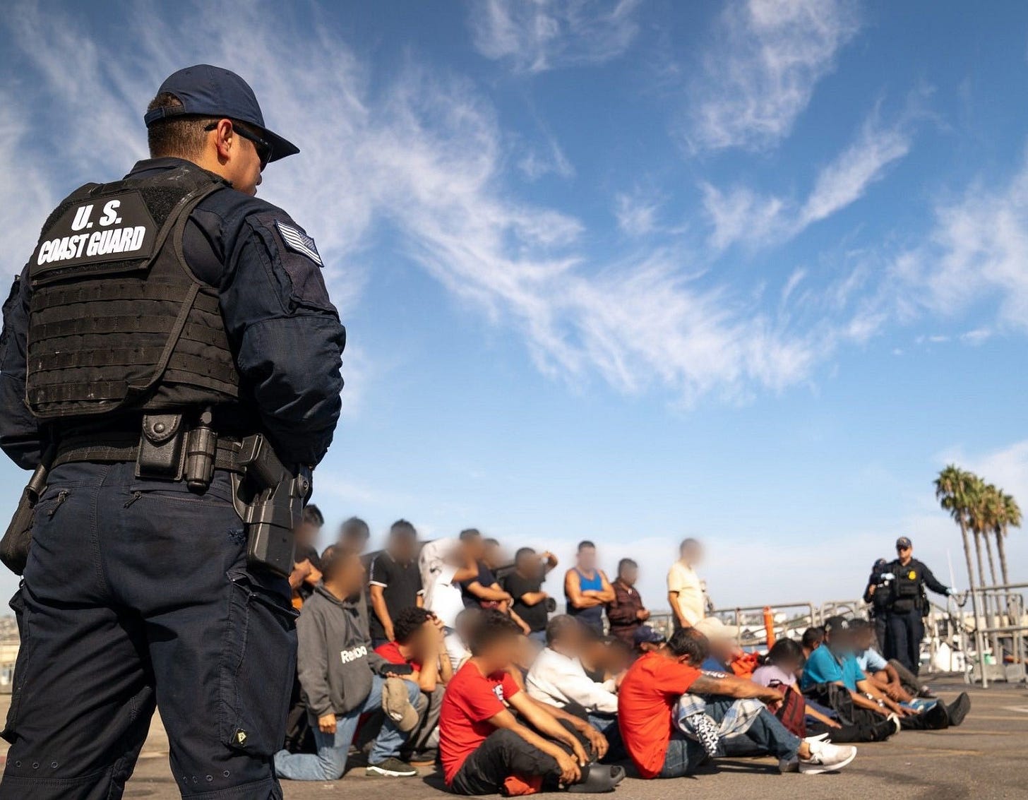 The US Coast Guard stands watch over the migrants in Long Beach until the Border Patrol takes custody of them. (US Coast Guard photo)