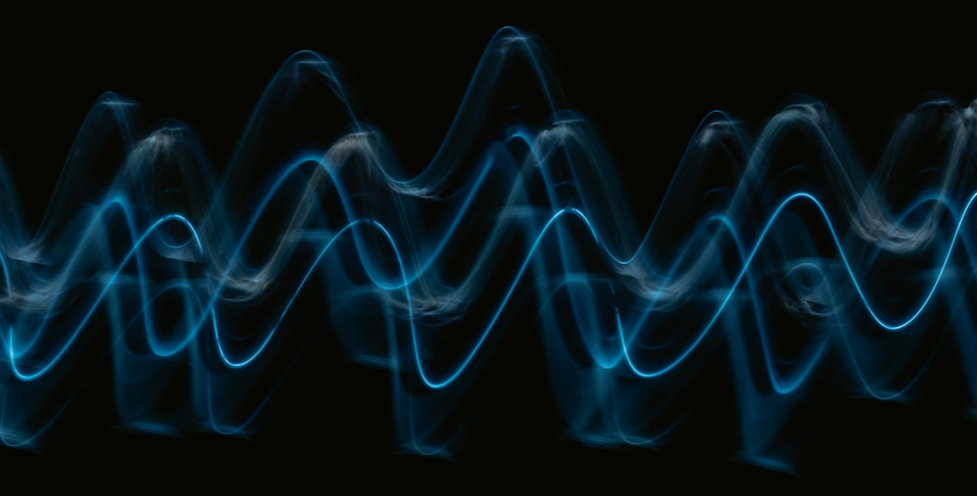 a black background with a blue wave of light