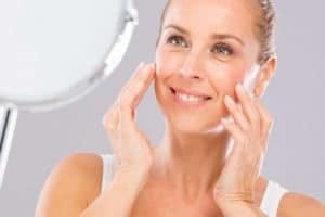 Woman looking in mirror smiling