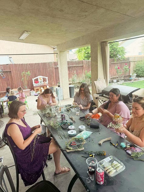 Dressed up Ladies gathering for sound bath, flower wreath making, and food