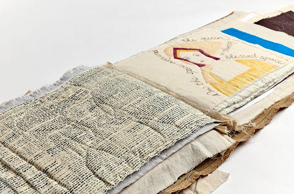 A large textile book lies open with an image of Jane Seymour on the further page. A large textile book lies open with an image of Jane Seymour on the further page.