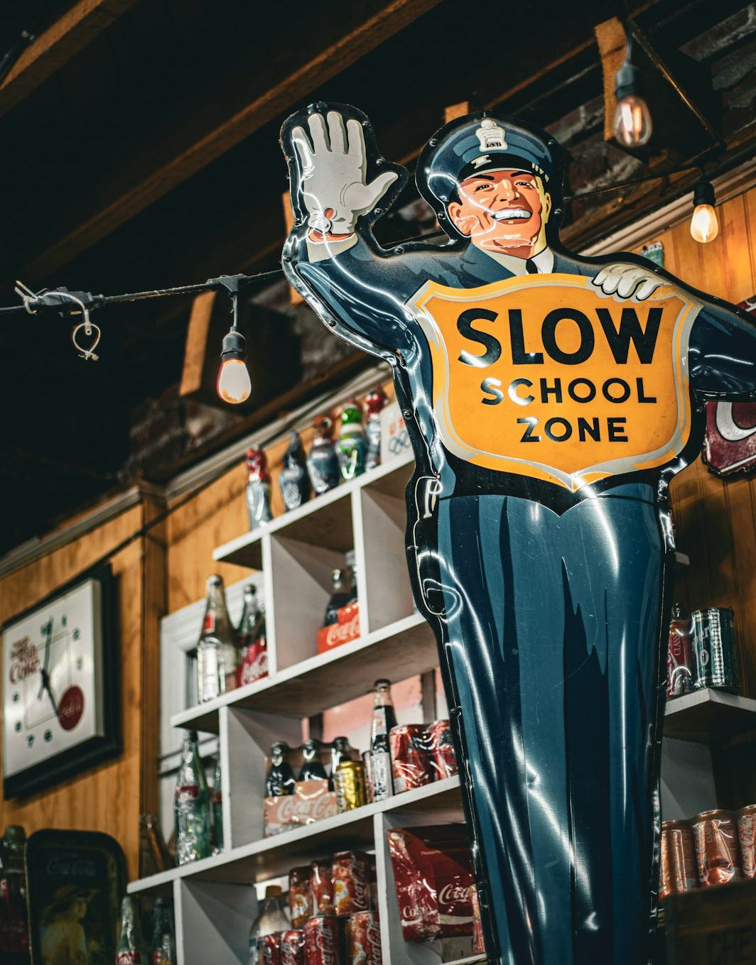 Vintage school zone sign with a smiling police officer