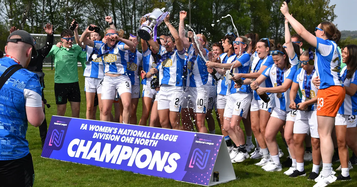 Huddersfield Town Women players celebrate winning Division One North.