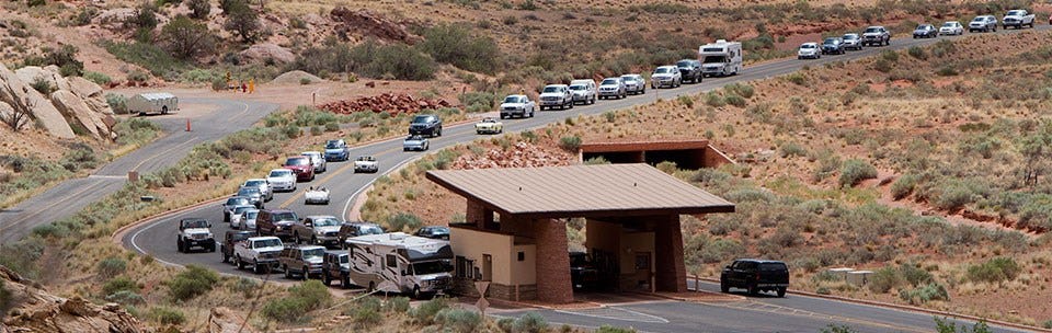 Two lanes of traffic lined up and waiting at the entrance station. Two lanes of traffic lined up and waiting at the entrance station.