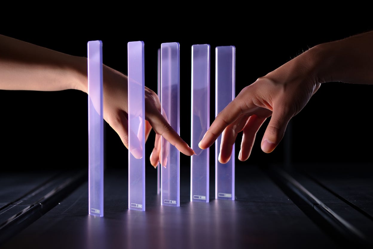 Two warm-toned human hands reaching toward each other through a series of cold, translucent lavender glass panels. At the base of each panel is a glowing digital progress bar labeled "Subscription." The background is a dark, metallic void.