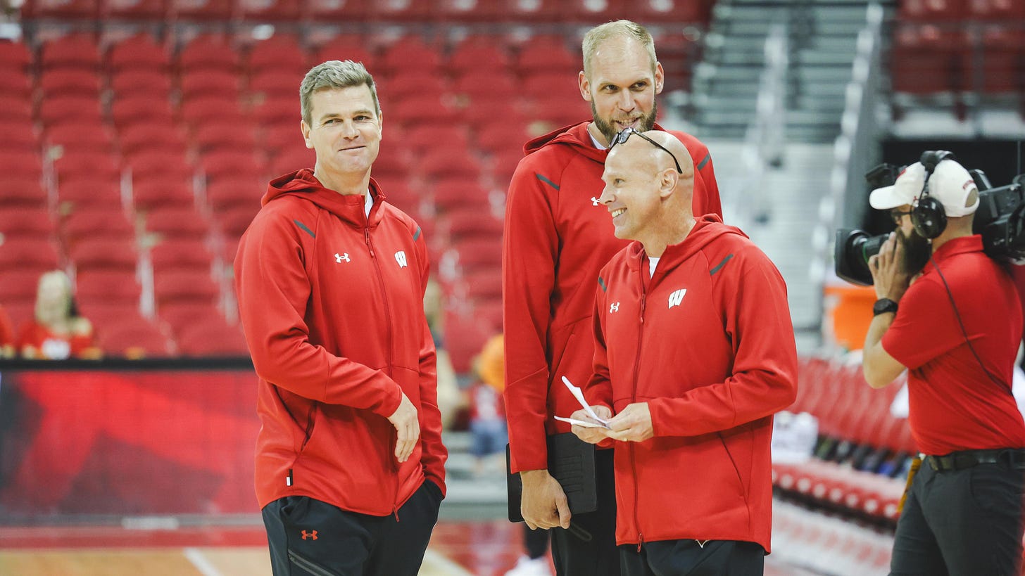 Wisconsin basketball assistant coach Lance Randall stands on the court alongside Greg Stiemsma and Kirk Penney before a game. Wisconsin basketball assistant coach Lance Randall stands on the court alongside Greg Stiemsma and Kirk Penney before a game.