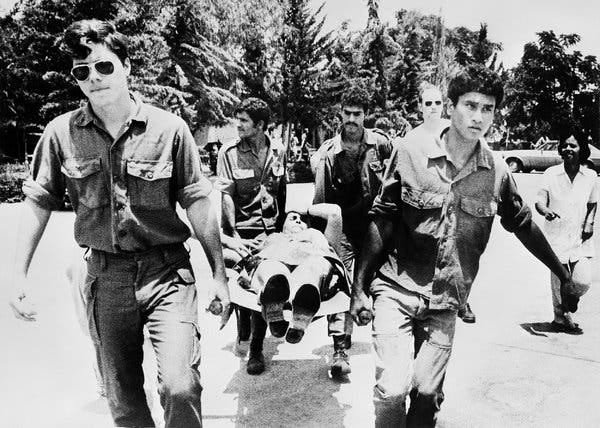 A group of men carrying a person on a stretcher

AI-generated content may be incorrect.