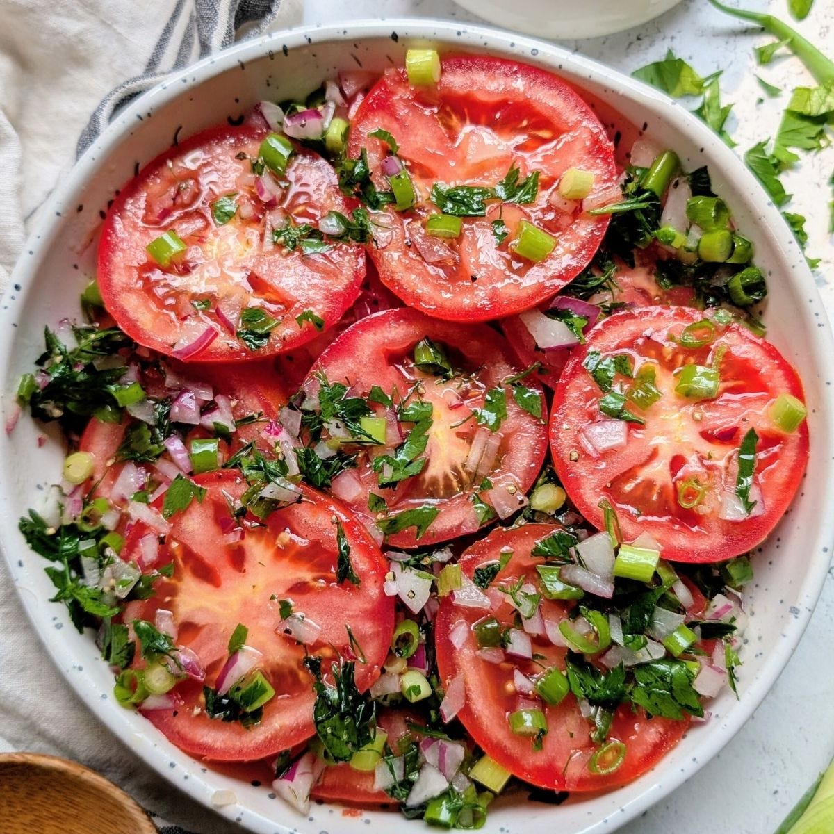 low sodium marinated tomato salad with fresh herbs and garlic in vinegar and oil dressing.