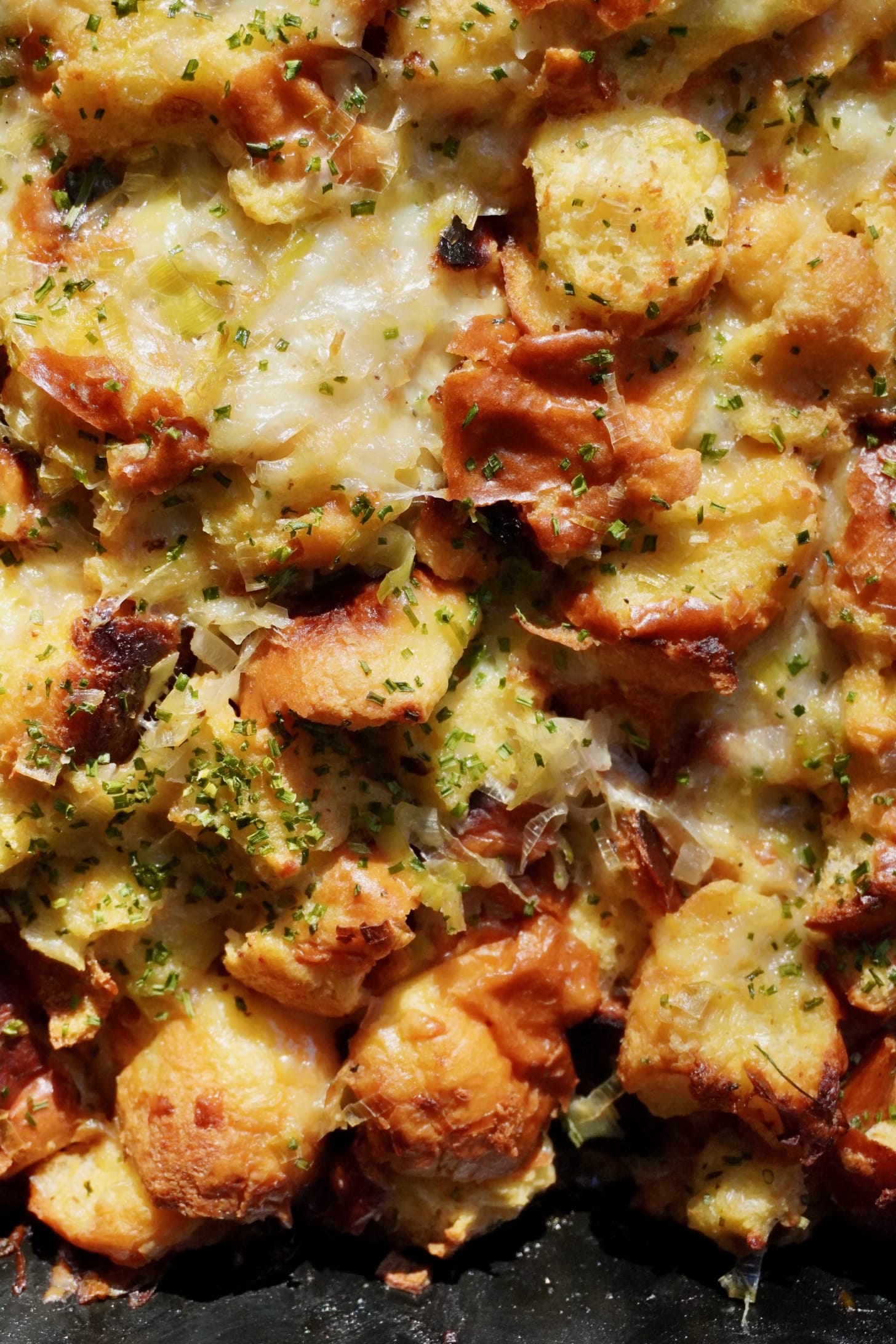 French-inspired brioche stuffing baked with Gruyère cheese, Cognac-sautéed leeks, and fresh chives — cozy holiday side dish for Friendsgiving.”