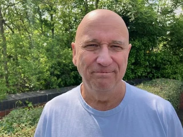 Cllr Paul Mann of Stavely Town, in a blue t shirt in front of some trees