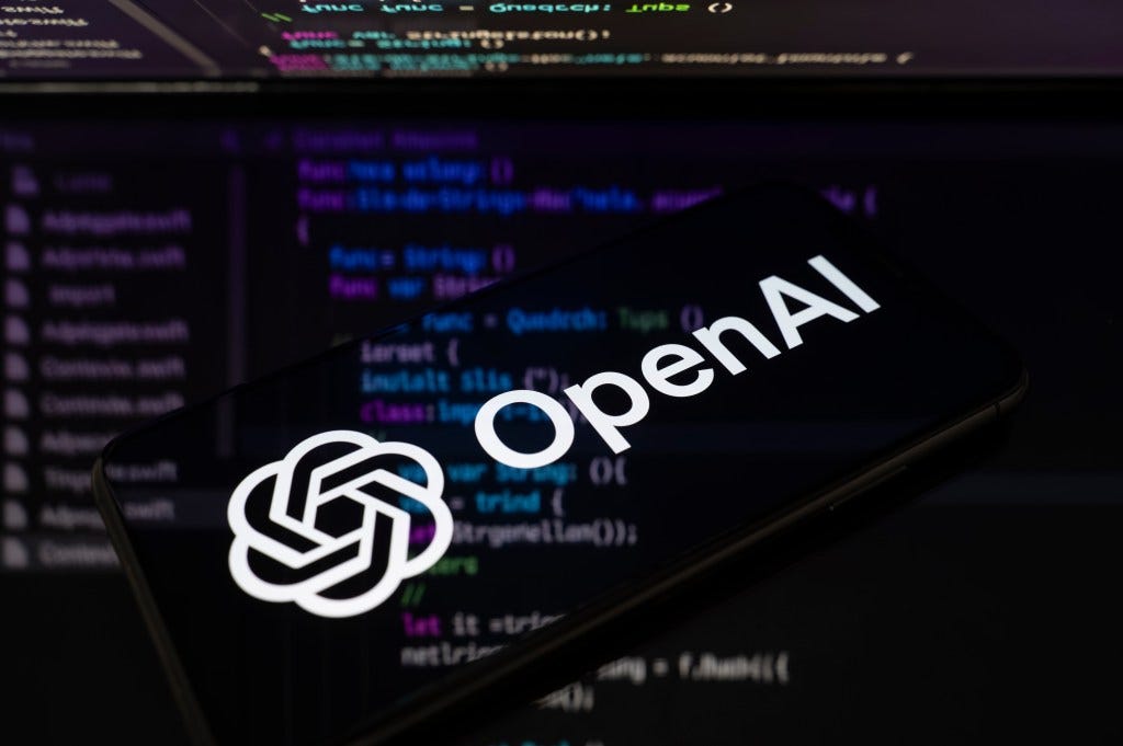 GPToast - The OpenAI logo is displayed on a smartphone screen placed on a reflective surface onto which lines of computer code.